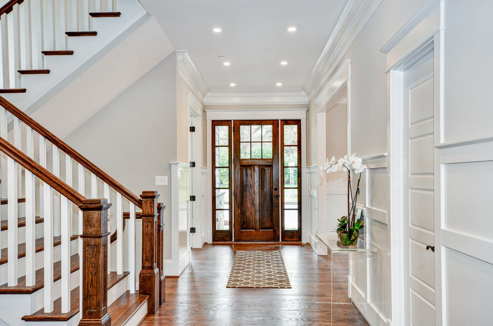 Inspiration for a large transitional foyer in DC Metro with white walls, dark hardwood floors, a single front door, a dark wood front door and brown floor.
