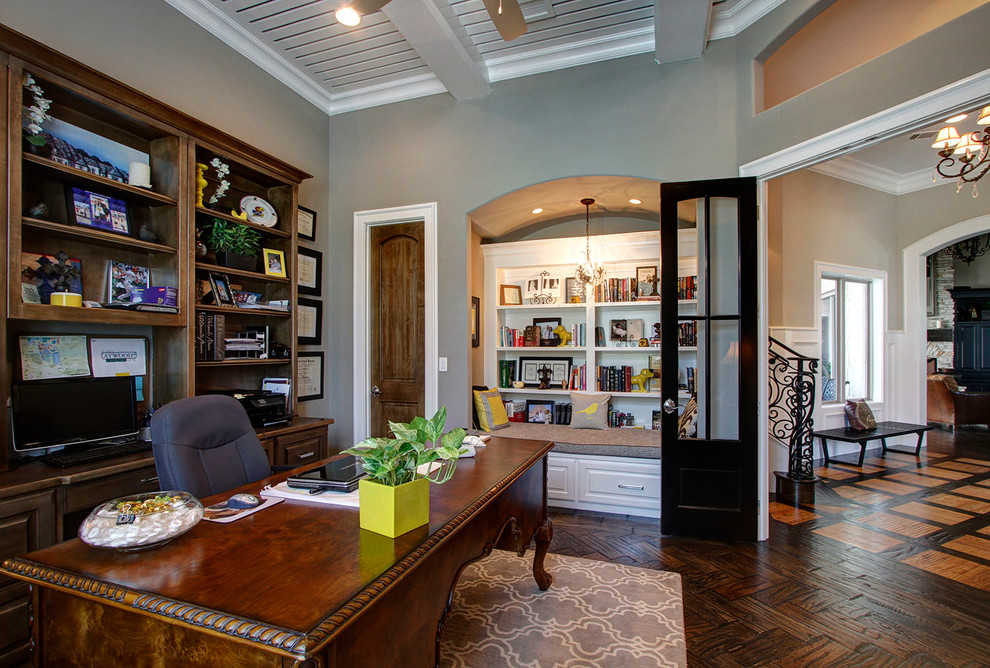 Traditional home office in Dallas with grey walls, dark hardwood floors and a freestanding desk.
