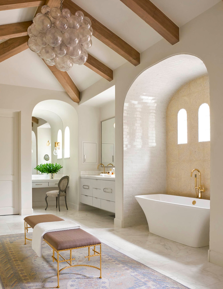 This is an example of a mediterranean bathroom in Dallas with flat-panel cabinets, white cabinets, a freestanding tub, white tile, subway tile and white walls.
