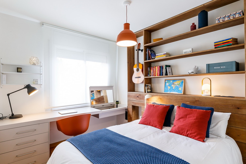 Mid-sized beach style gender-neutral kids' room in Barcelona with white walls.