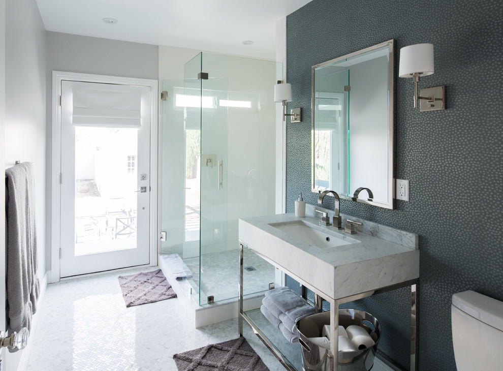 Mid-sized transitional bathroom in Los Angeles with a pedestal sink, marble benchtops, a one-piece toilet, gray tile, stone tile, grey walls and marble floors.
