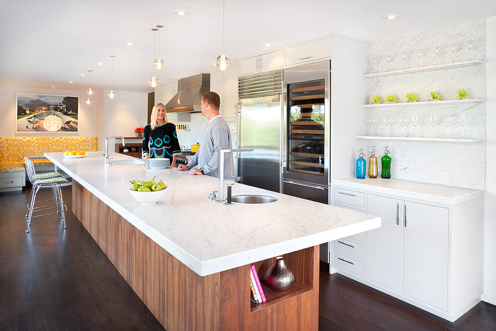 Photo of a midcentury galley kitchen in San Francisco with open cabinets, white cabinets, marble benchtops, white splashback, stone slab splashback and stainless steel appliances.