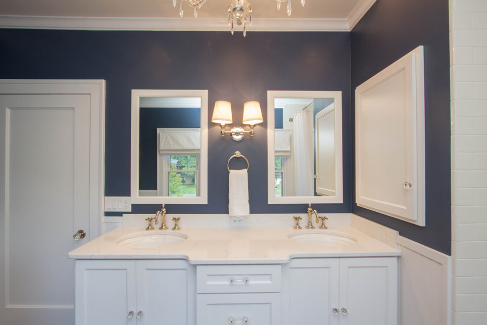 Large transitional kids' white tile and ceramic tile alcove bathtub photo with raised-panel cabinets, white cabinets, a two-piece toilet, blue walls, an undermount sink and granite countertops