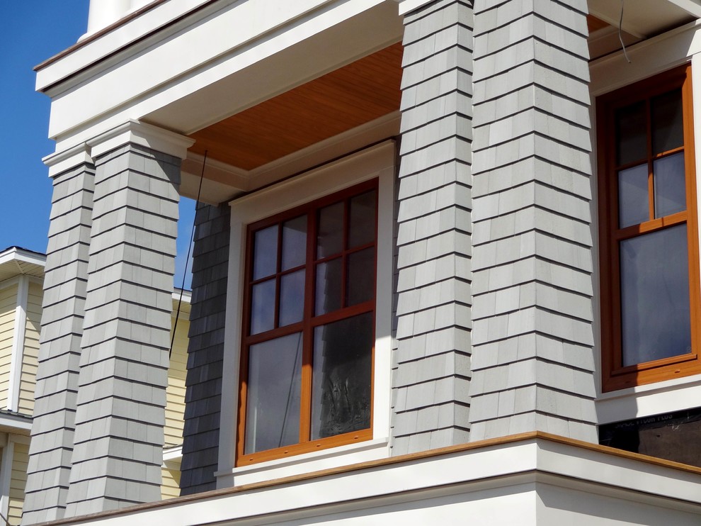 This is an example of a beach style grey exterior in Charleston.