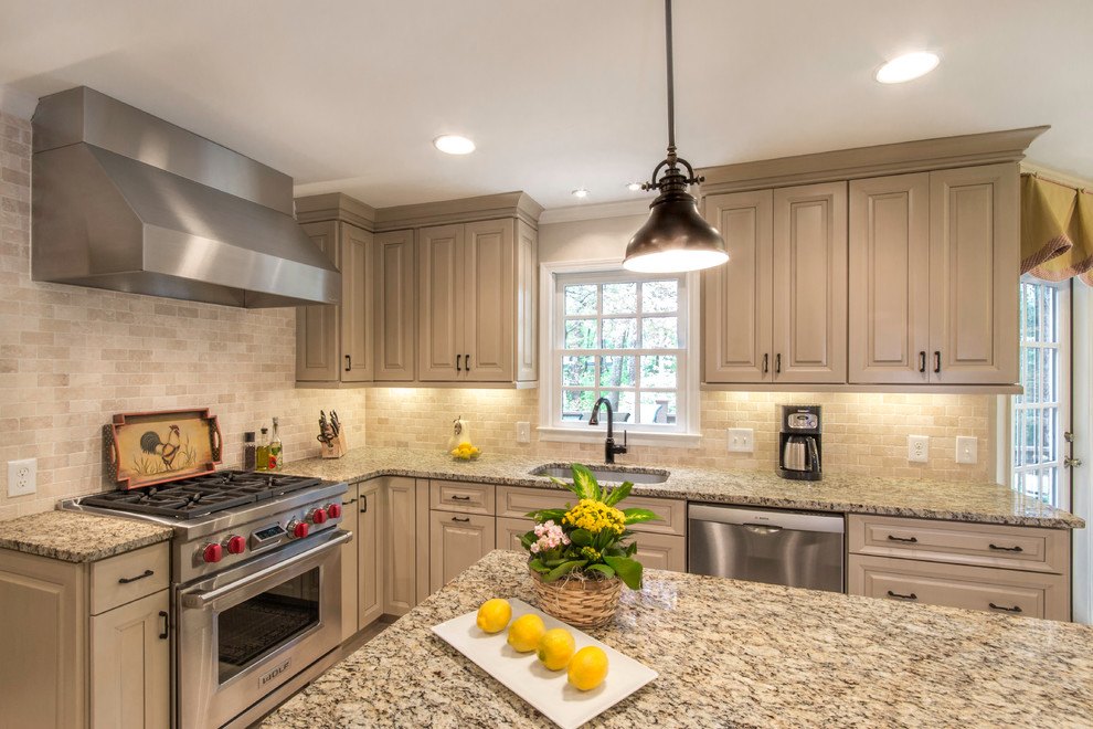 This is an example of a traditional kitchen in Atlanta with a single-bowl sink, raised-panel cabinets, beige cabinets, granite benchtops, stone tile splashback, stainless steel appliances and beige splashback.