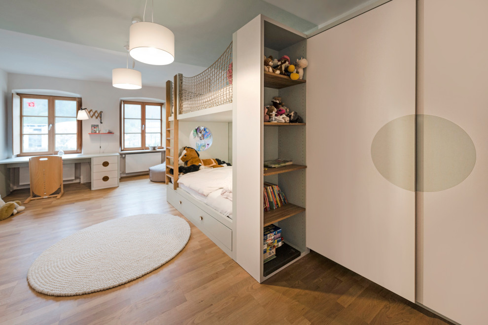 Inspiration for a large contemporary girl medium tone wood floor and brown floor childrens' room remodel in Other with green walls