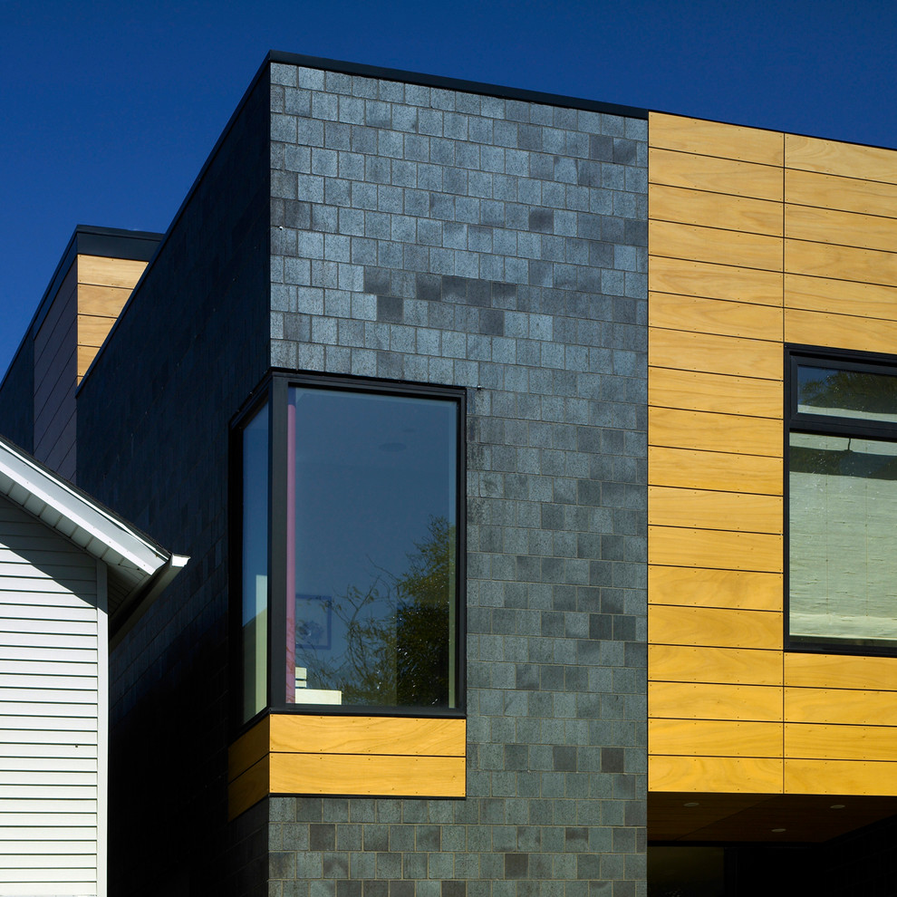 Design ideas for a mid-sized modern three-storey brick black house exterior in Chicago.