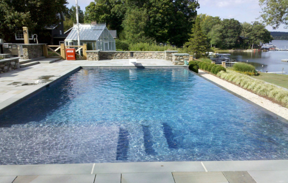 Example of a large transitional backyard tile and rectangular pool design in New York