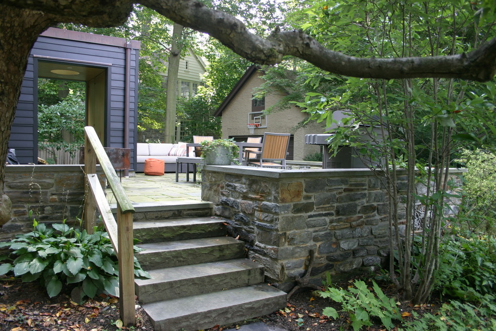 Mid-sized traditional backyard patio in Philadelphia with natural stone pavers and no cover.