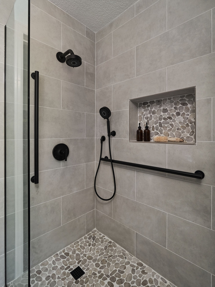 Photo of a medium sized classic shower room bathroom in Portland with shaker cabinets, brown cabinets, a built-in shower, grey tiles, porcelain tiles, blue walls, porcelain flooring, a submerged sink, engineered stone worktops, grey floors, a hinged door, beige worktops, a wall niche, a single sink and a built in vanity unit.