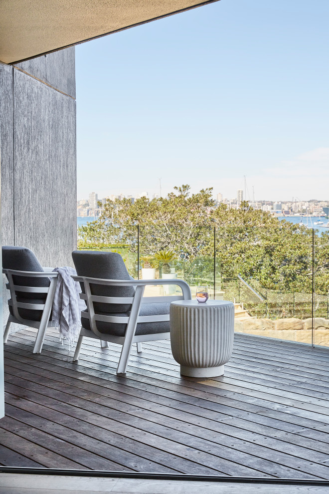 Contemporary first floor deck in Sydney with glass railing.