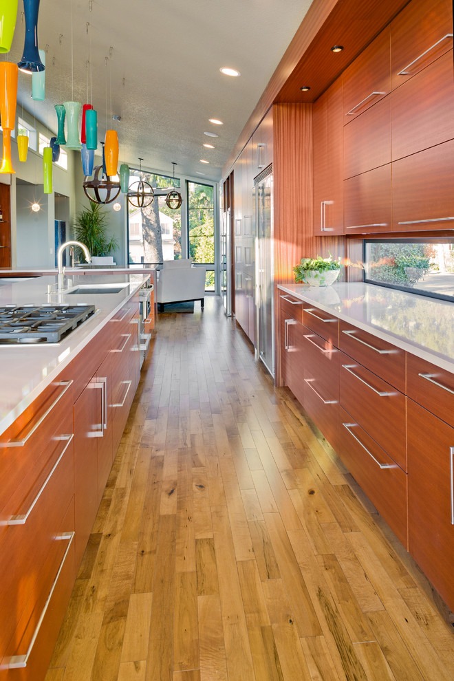 Eat-in kitchen - large light wood floor eat-in kitchen idea in Minneapolis with an undermount sink, medium tone wood cabinets, stainless steel appliances and an island