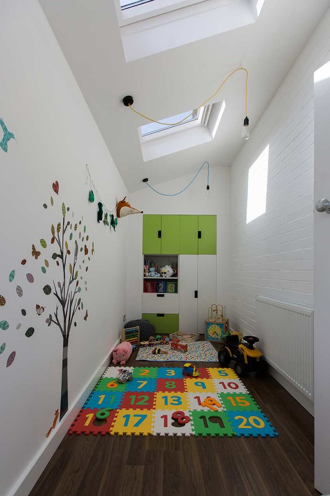 Mid-sized contemporary gender-neutral kids' room in Other with white walls and dark hardwood floors.