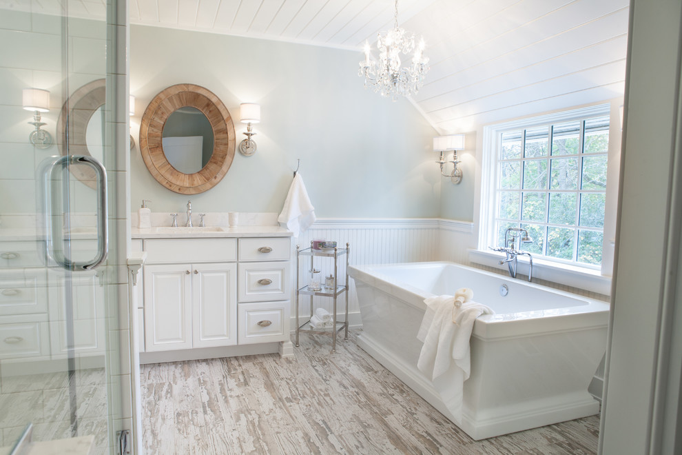 Inspiration for a mid-sized country master bathroom in Chicago with an undermount sink, raised-panel cabinets, white cabinets, quartzite benchtops, multi-coloured tile, subway tile, green walls, porcelain floors and a freestanding tub.