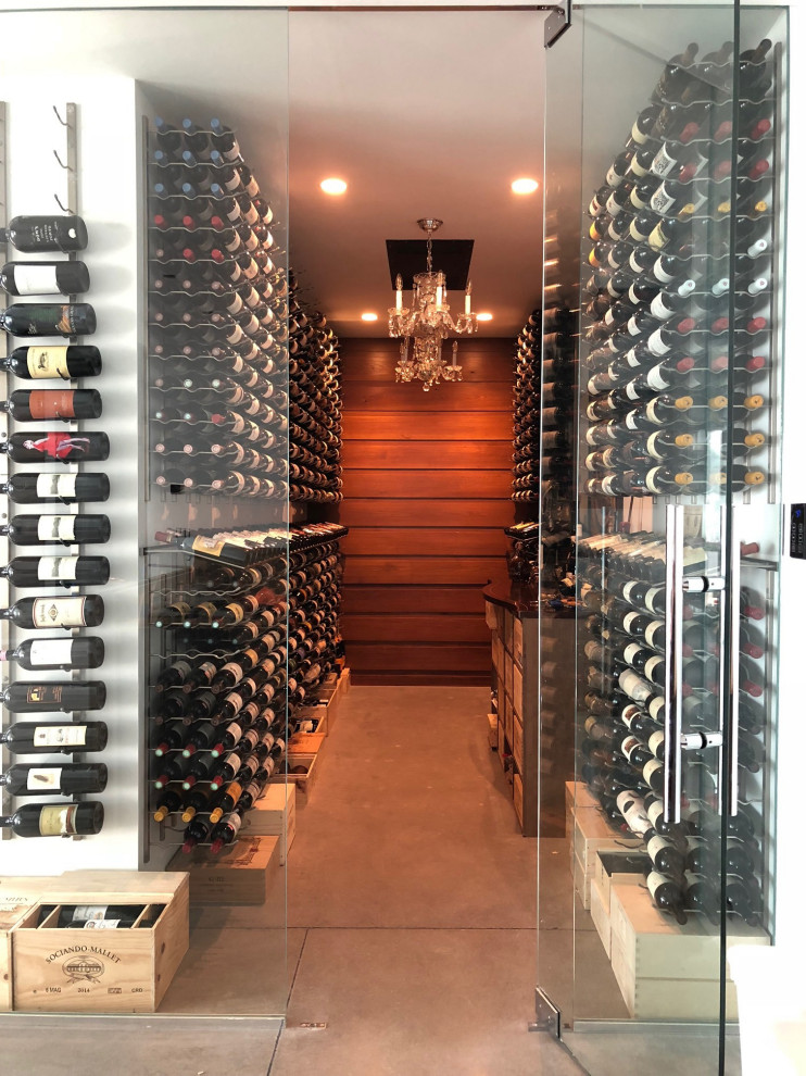 Design ideas for a large transitional wine cellar in New York with concrete floors and storage racks.