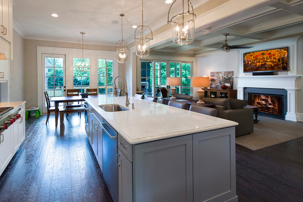 Large traditional l-shaped open plan kitchen in Atlanta with an undermount sink, white cabinets, granite benchtops, stainless steel appliances, dark hardwood floors, with island, shaker cabinets, grey splashback and ceramic splashback.