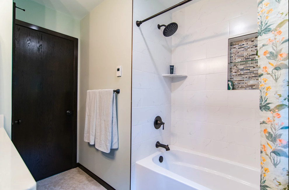 Photo of a small traditional bathroom in Minneapolis with shaker cabinets, dark wood cabinets, an alcove tub, a shower/bathtub combo, white tile, ceramic tile, blue walls, ceramic floors, an undermount sink, engineered quartz benchtops, brown floor, a shower curtain, white benchtops, a niche, a single vanity and a freestanding vanity.