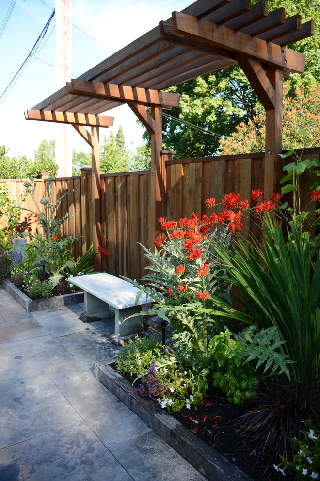 Mid-sized transitional backyard full sun garden in Vancouver with a vegetable garden and natural stone pavers.
