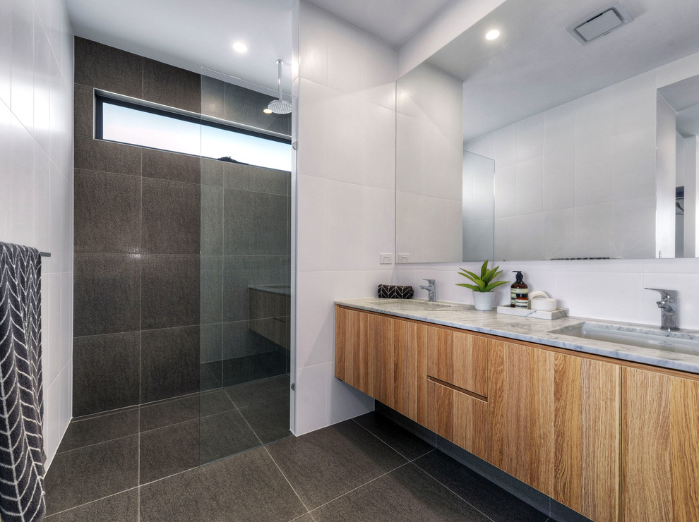 Transitional master bathroom in Brisbane with medium wood cabinets, an open shower, black and white tile, ceramic tile, white walls, ceramic floors, an undermount sink and marble benchtops.