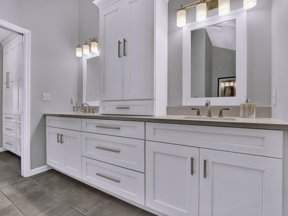 Inspiration for a medium sized classic ensuite bathroom in St Louis with shaker cabinets, white cabinets, a walk-in shower, white tiles, metro tiles, grey walls, ceramic flooring, a submerged sink, engineered stone worktops, grey floors, an open shower, grey worktops, a shower bench, double sinks and a built in vanity unit.