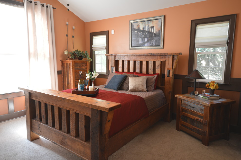 This is an example of an arts and crafts bedroom in Charlotte with orange walls and carpet.