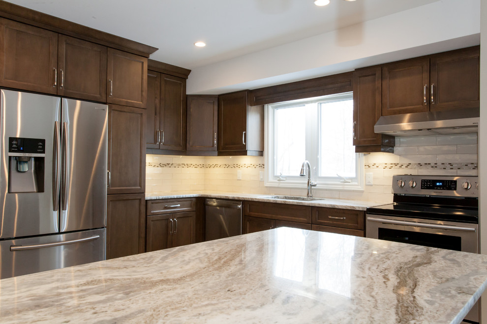 Inspiration for a mid-sized transitional u-shaped porcelain tile eat-in kitchen remodel in Toronto with an undermount sink, recessed-panel cabinets, dark wood cabinets, granite countertops, white backsplash, porcelain backsplash, stainless steel appliances and a peninsula