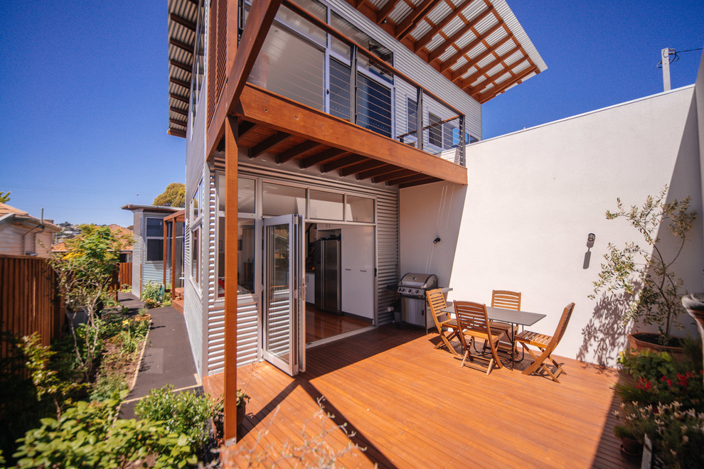 Inspiration for a contemporary backyard deck in Hobart with a roof extension.