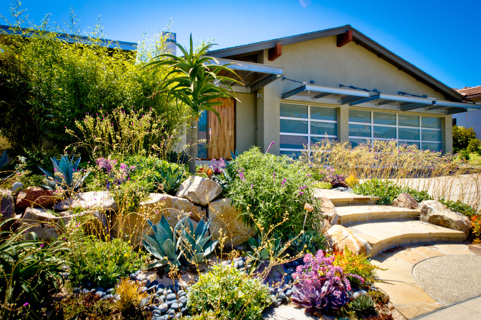 Contemporary front yard full sun xeriscape in San Diego with natural stone pavers.