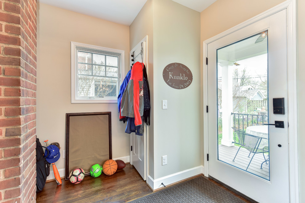 Design ideas for a mid-sized traditional mudroom with beige walls, a single front door and a glass front door.