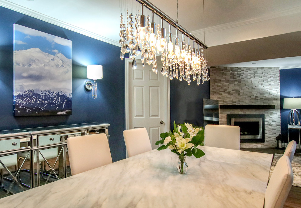 This is an example of a mid-sized transitional dining room in Toronto with blue walls, vinyl floors, a corner fireplace, a tile fireplace surround and grey floor.
