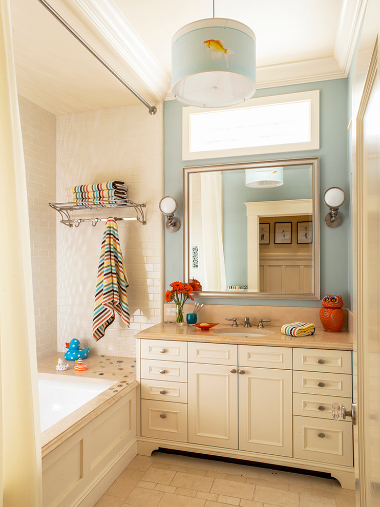 Inspiration for a mid-sized transitional kids bathroom in San Francisco with an undermount sink, recessed-panel cabinets, white cabinets, an undermount tub, a shower/bathtub combo, beige tile, blue walls and a shower curtain.