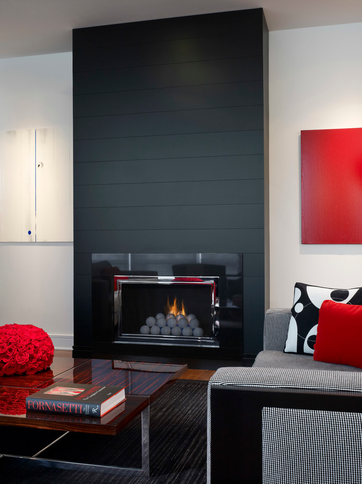 Photo of a mid-sized modern formal living room in Chicago with a standard fireplace, white walls, medium hardwood floors and a tile fireplace surround.