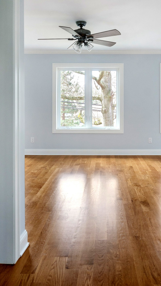 Living Room with Ceiling Fan and Crown Trim