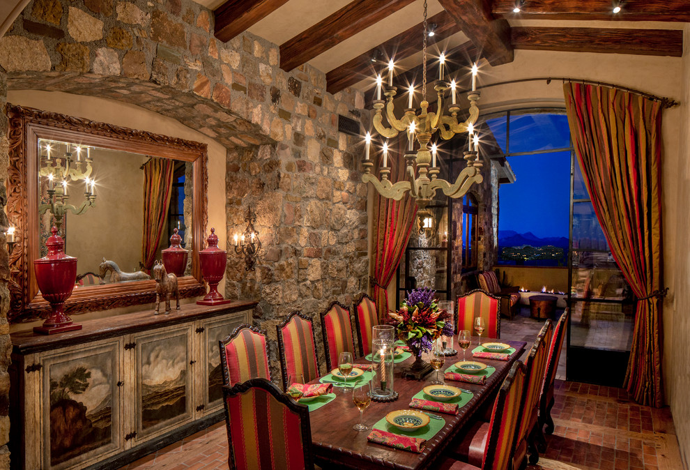 This is an example of a country separate dining room in Phoenix with brown walls and brick floors.
