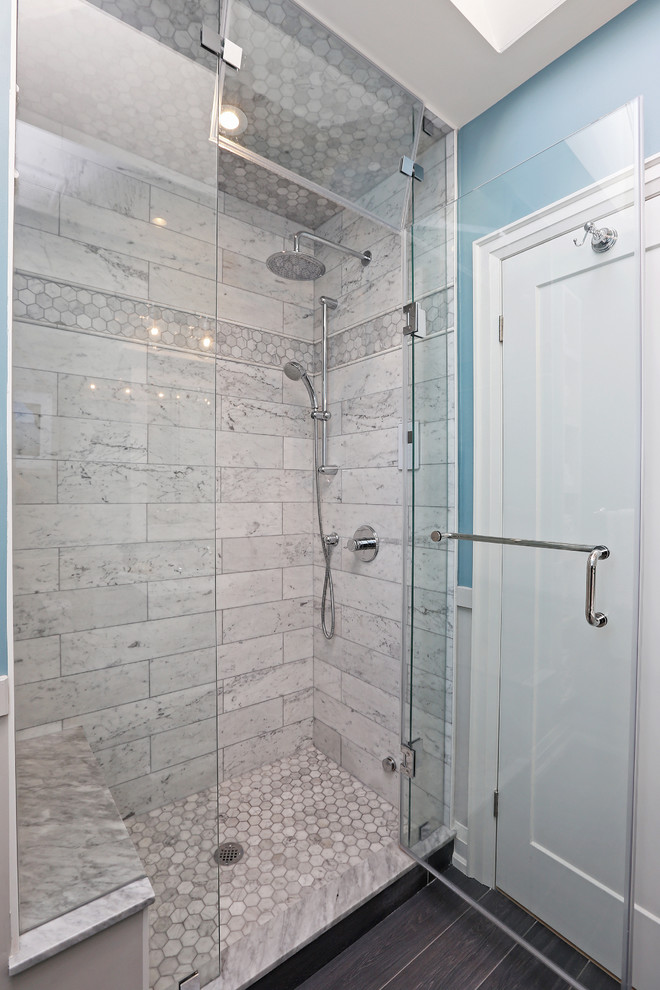 This is an example of a small transitional master bathroom in Toronto with white cabinets, an alcove shower, a one-piece toilet, white tile, marble, blue walls, an undermount sink, grey floor and a hinged shower door.