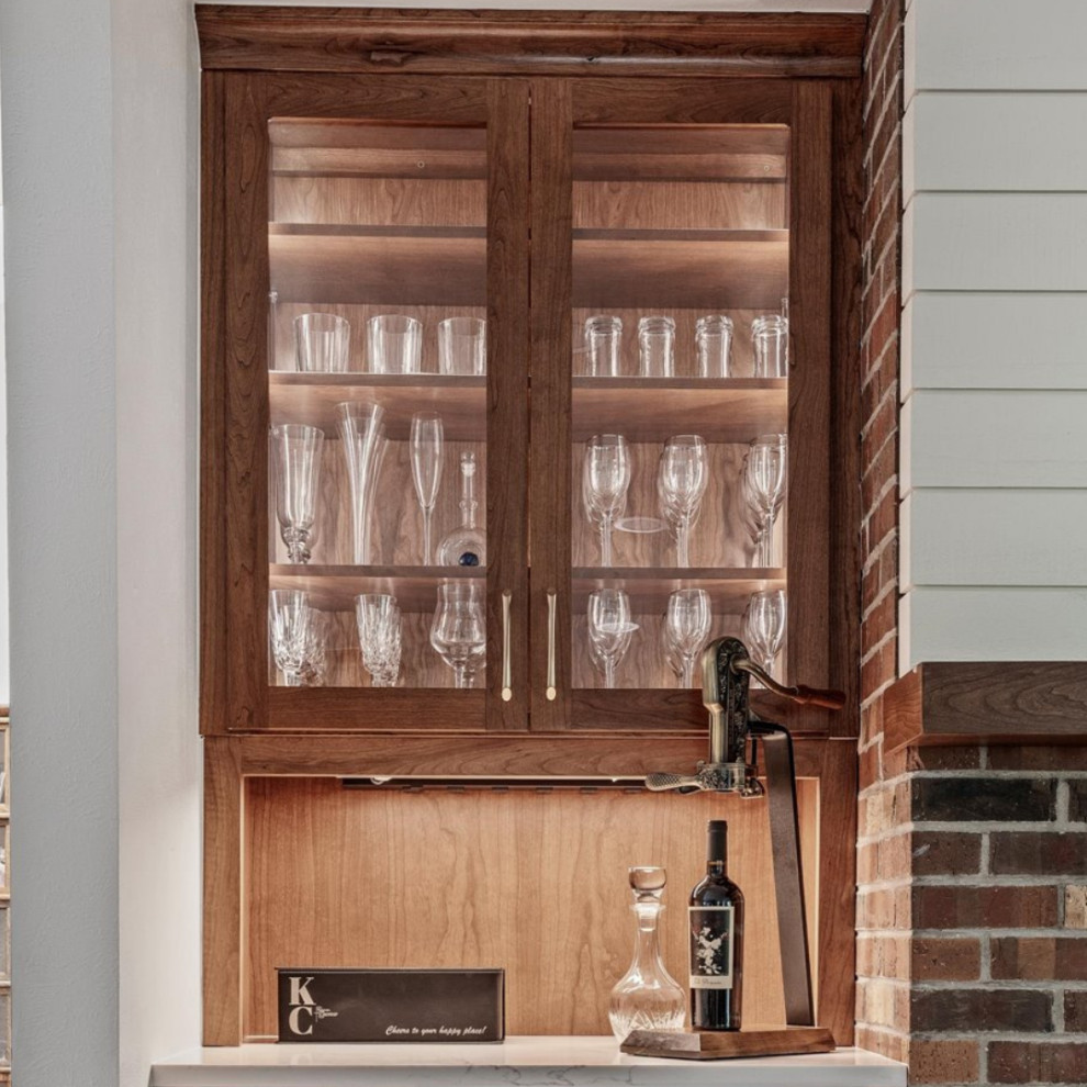 Inspiration for a large transitional l-shaped light wood floor and brown floor eat-in kitchen remodel in Denver with an undermount sink, flat-panel cabinets, medium tone wood cabinets, quartzite countertops, white backsplash, ceramic backsplash, stainless steel appliances, an island and white countertops