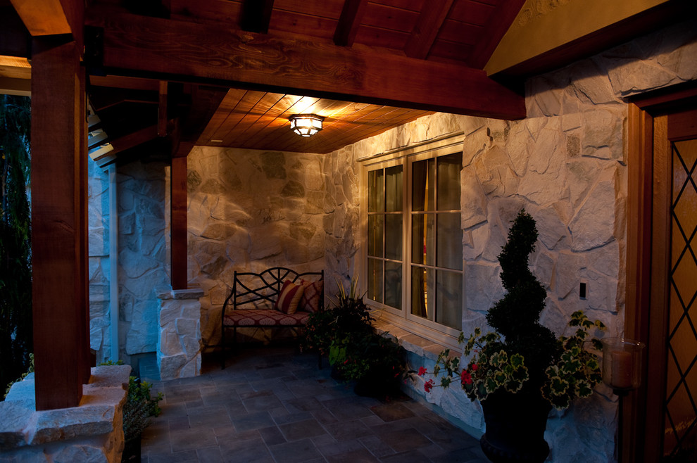 This is an example of a large traditional two-storey beige exterior in Seattle with stone veneer.