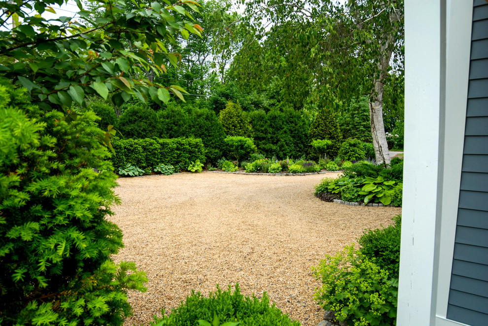 Design ideas for a mid-sized country courtyard partial sun driveway in Boston with gravel.