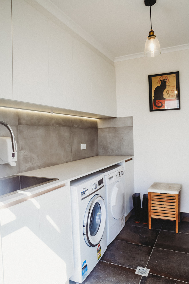 Mid-sized traditional galley dedicated laundry room in Canberra - Queanbeyan with an undermount sink, flat-panel cabinets, white cabinets, quartz benchtops, white walls, ceramic floors, a side-by-side washer and dryer and grey floor.