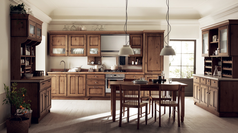 This is an example of a large eclectic u-shaped eat-in kitchen in Melbourne with a double-bowl sink, raised-panel cabinets, medium wood cabinets, tile benchtops, stone tile splashback, light hardwood floors and multiple islands.