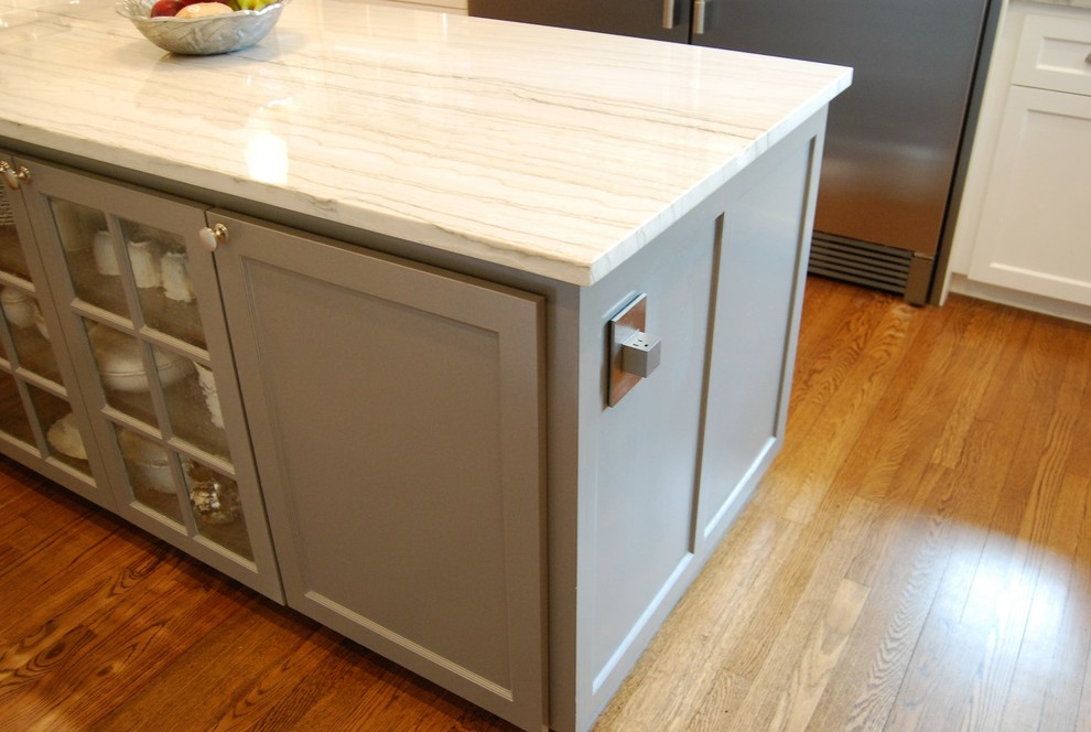 Kitchen - mid-sized transitional u-shaped light wood floor kitchen idea in Austin with a farmhouse sink, shaker cabinets, white cabinets, quartzite countertops, beige backsplash, porcelain backsplash, stainless steel appliances and an island