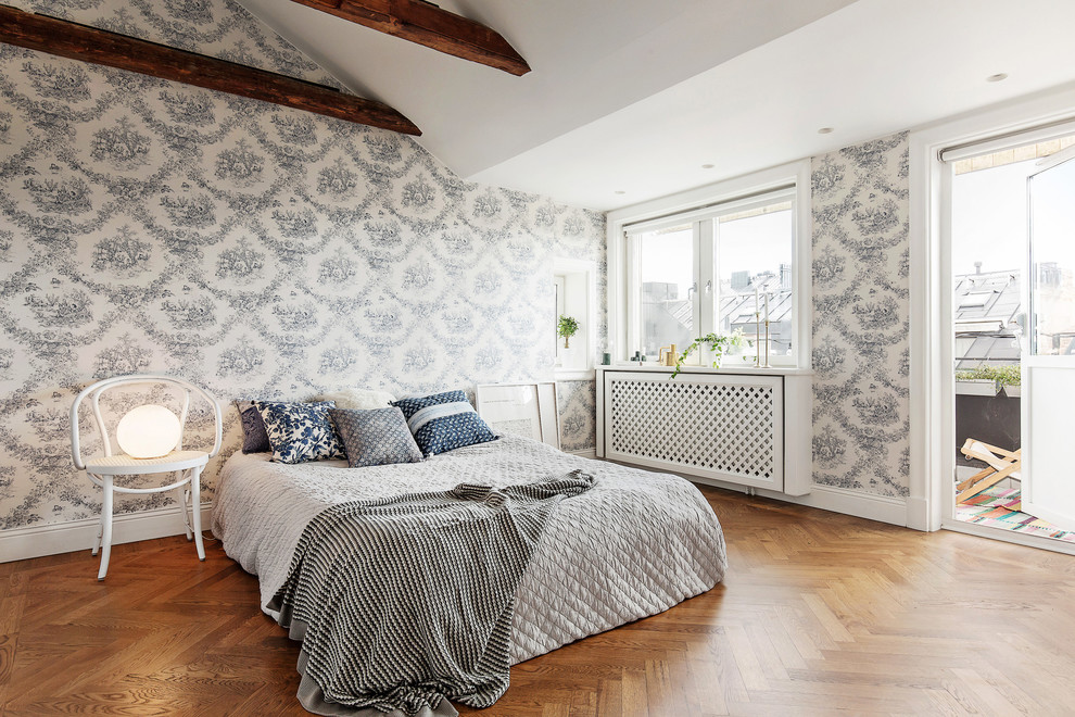 Large scandinavian master bedroom in Stockholm with multi-coloured walls, medium hardwood floors and no fireplace.