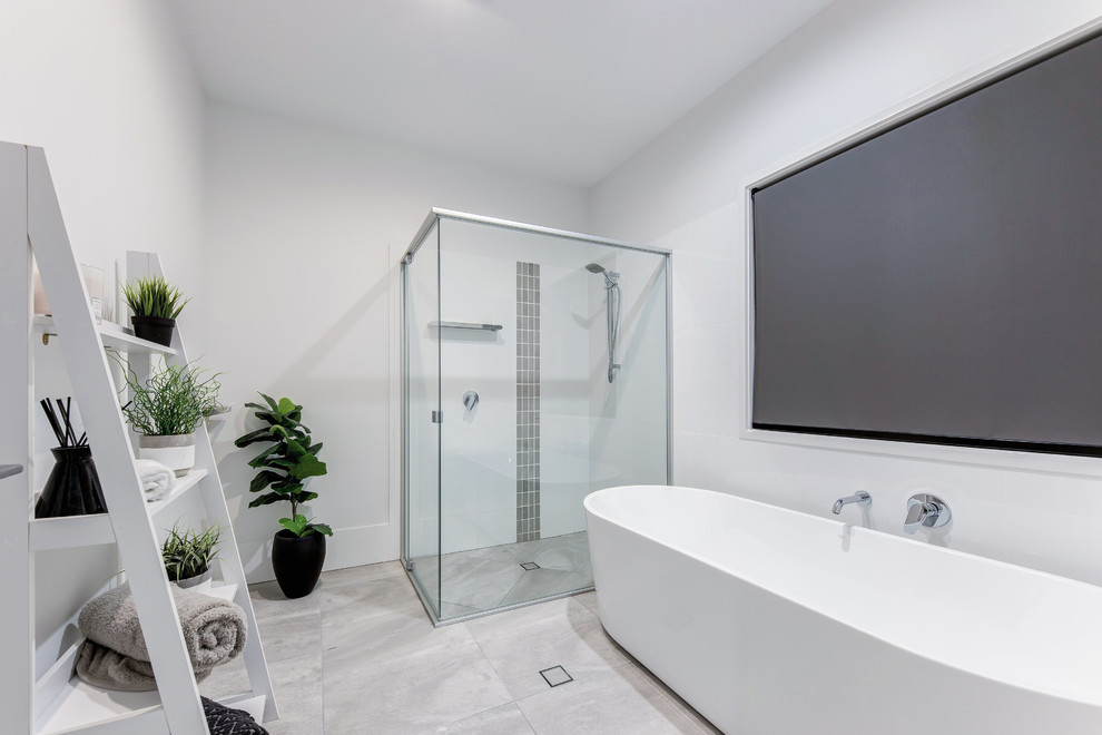 Design ideas for a contemporary master bathroom in Sunshine Coast with a freestanding tub, a corner shower, gray tile, white walls, grey floor and a hinged shower door.