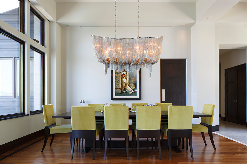 This is an example of a contemporary dining room in San Francisco with white walls and medium hardwood floors.