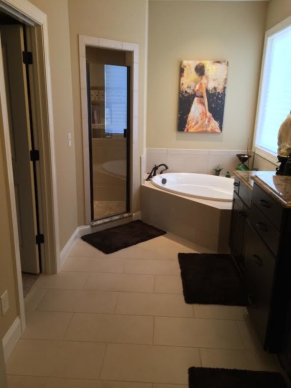 Mid-sized transitional master beige tile and ceramic tile porcelain tile bathroom photo in Raleigh with granite countertops