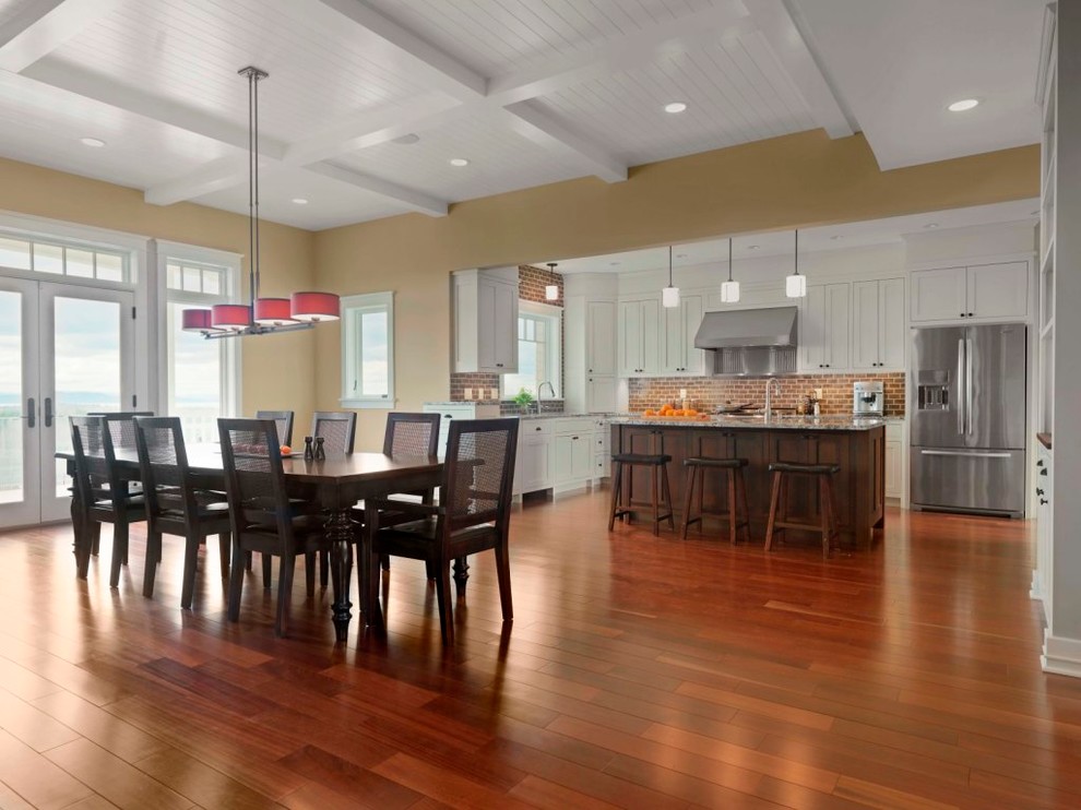 Expansive traditional kitchen/dining combo in Burlington with beige walls, medium hardwood floors, brown floor and timber.