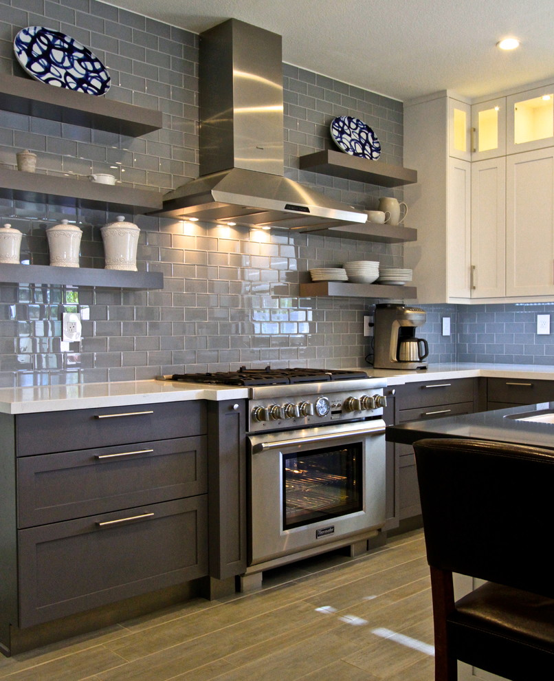 Transitional porcelain tile kitchen photo in Orange County with glass tile backsplash and an island