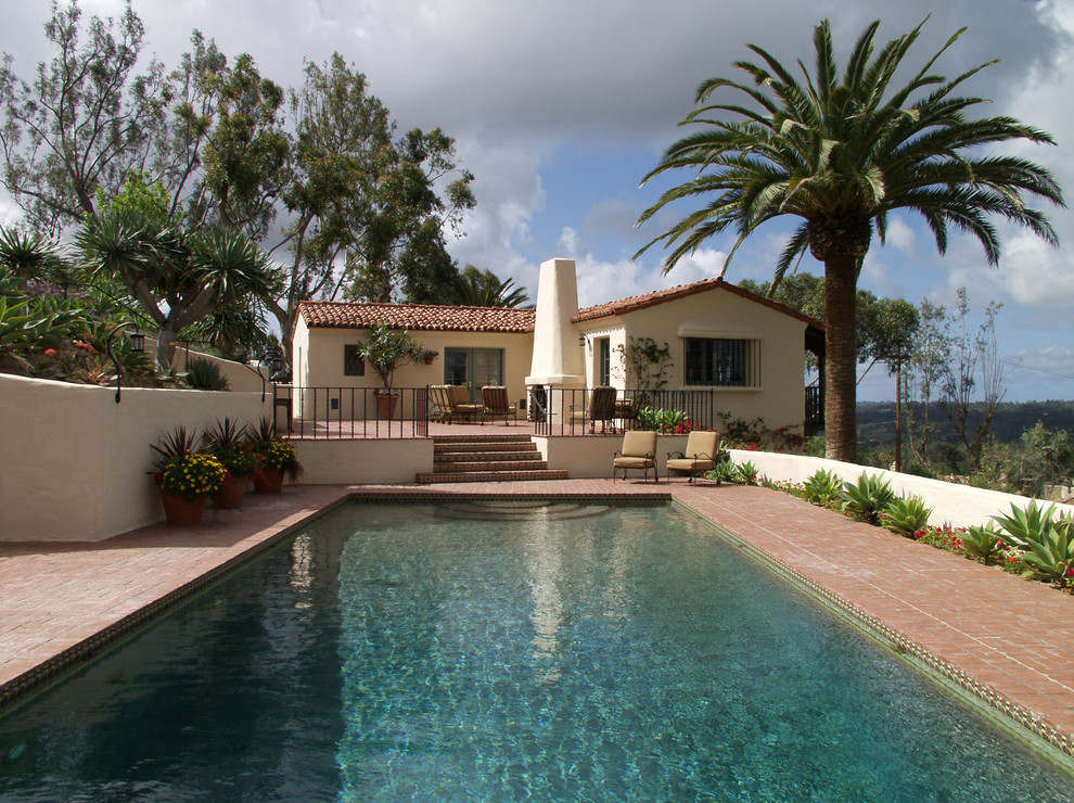 Design ideas for a mid-sized mediterranean backyard rectangular lap pool in San Diego with brick pavers.