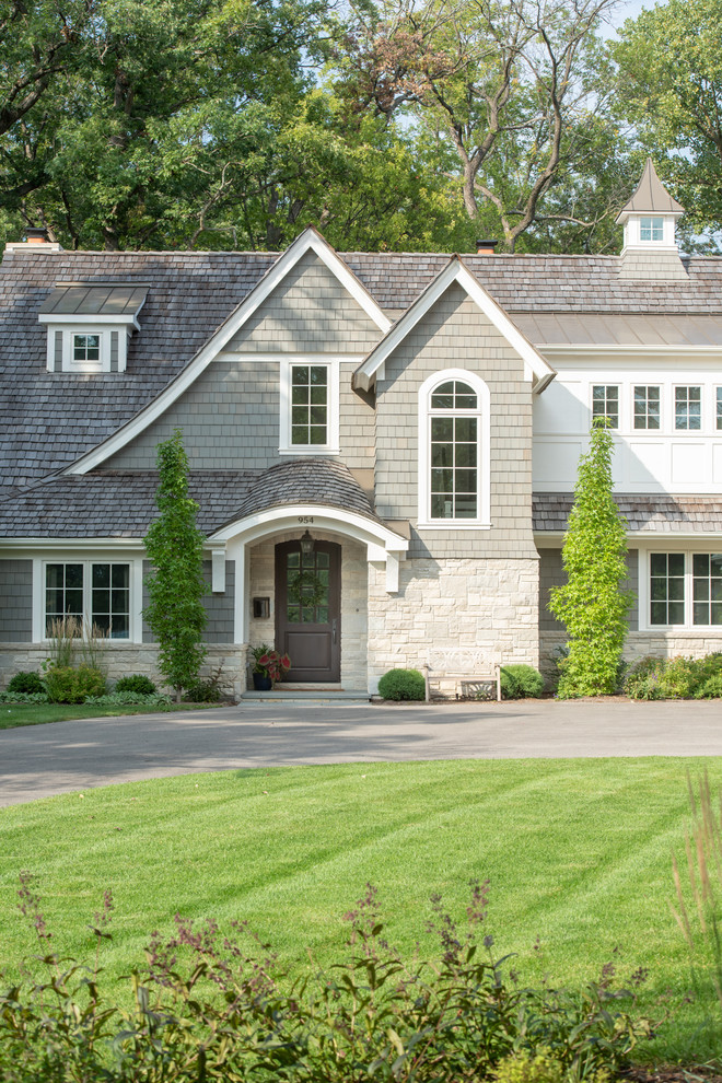 Inspiration for a large transitional two-storey green house exterior in Chicago with mixed siding, a gable roof and a shingle roof.