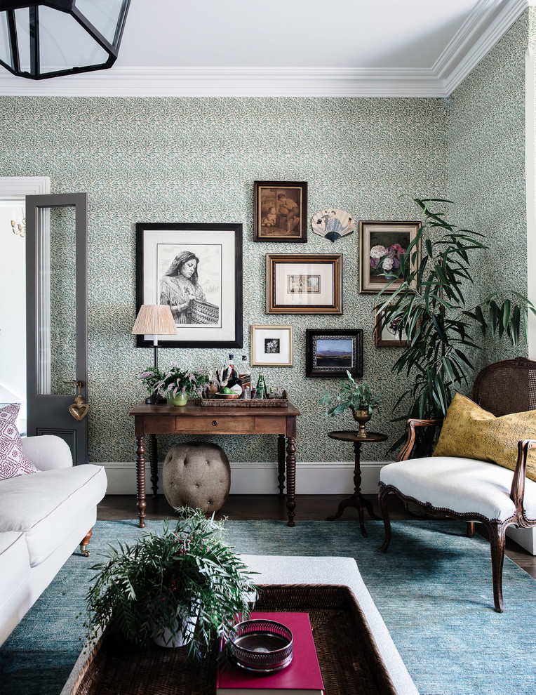Traditional enclosed living room in Sydney with green walls and dark hardwood floors.
